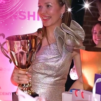 Elena Kaligina holding the winner's cup at WULOP USA 2024